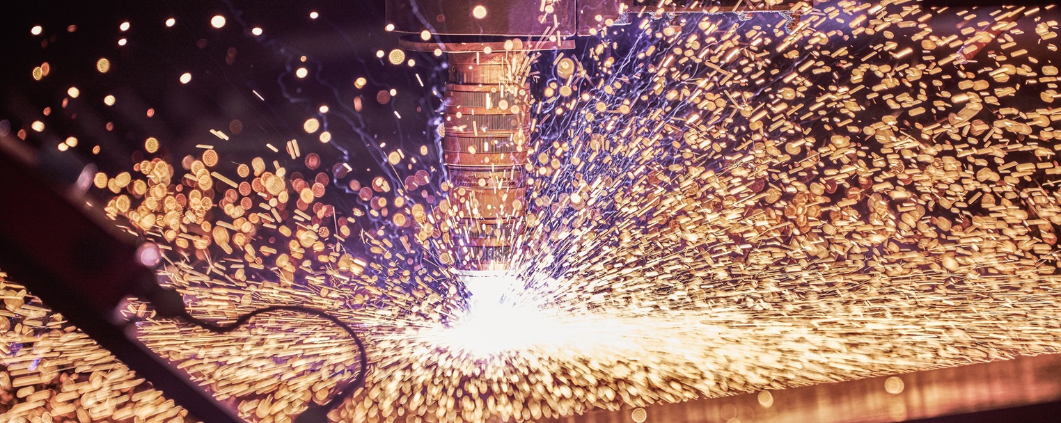 Während eines Schweißvorgangs sprühen Funken in einem hellen Lichtblitz, wobei ein unscharfer Hintergrund einen dynamischen Effekt erzeugt.